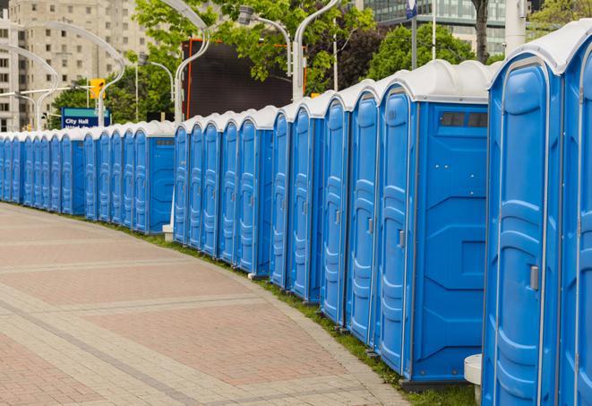 a row of portable restrooms set up for a large athletic event, allowing participants and spectators to easily take care of their needs in Cranbury